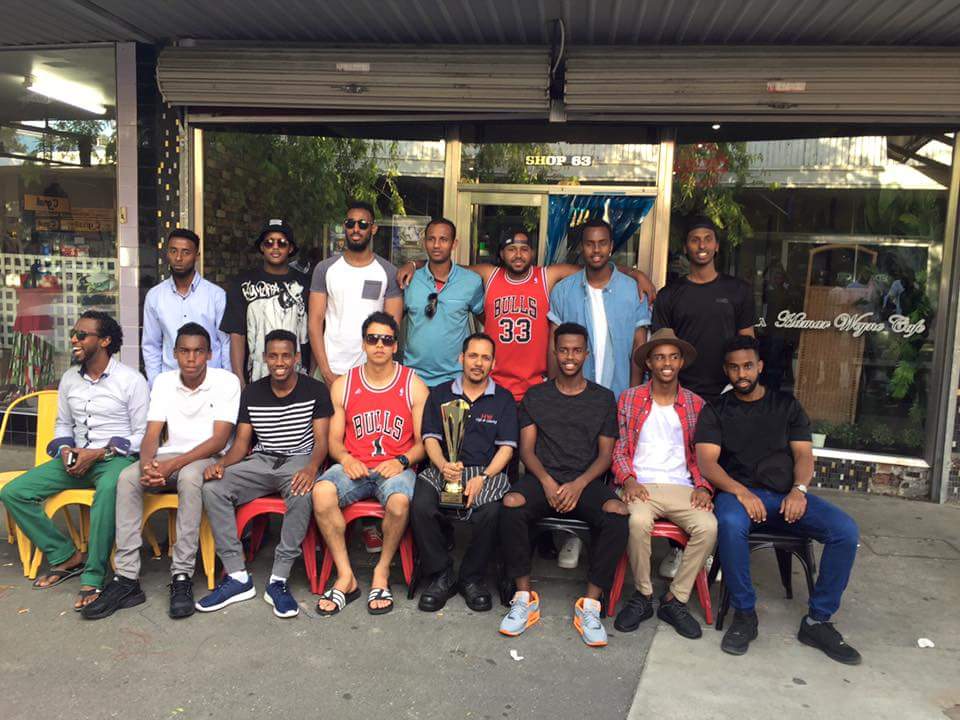 Hamar Weyne Café outside the Heidelberg shopfront with sponsored community team